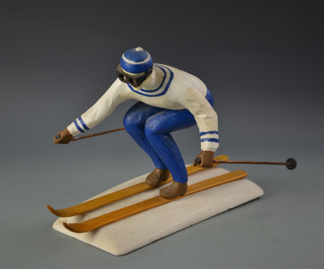 Blue and White Wooden Skier: Western, carved wooden skier in blue and white with emblem, circa 1960s. Measurement 8 1/2 in., 13 in.