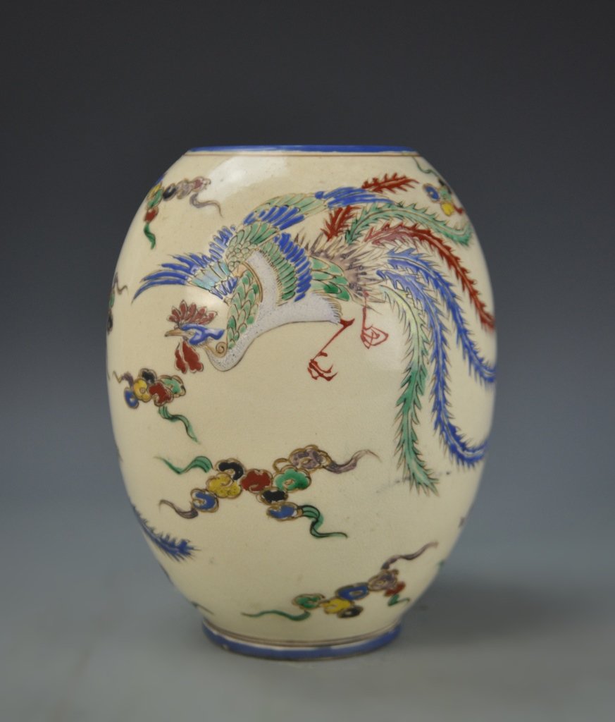 Chinese Famille Rose Jar: China, 19th C., Famille Rose jar, on a slightly raised base, with high, square shoulders, glazed in a cream ground, decorated with a brightly painted, raised phoenix and cloud design. Height 7 1/2 in.