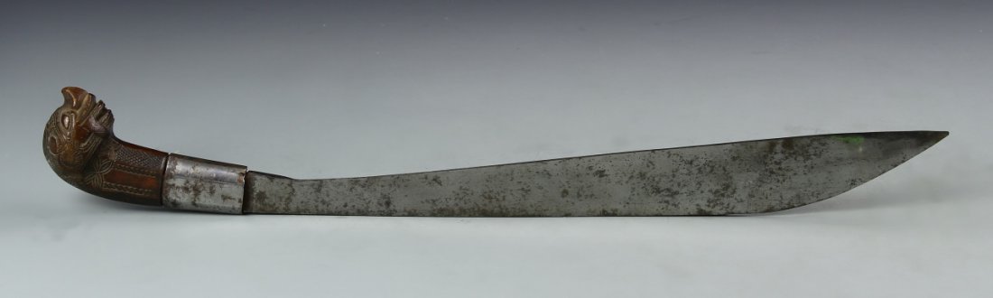 Asian Antique Dagger: Asia, antique dagger. With brown mythical beast head handle and curved blade. Height 22 in.