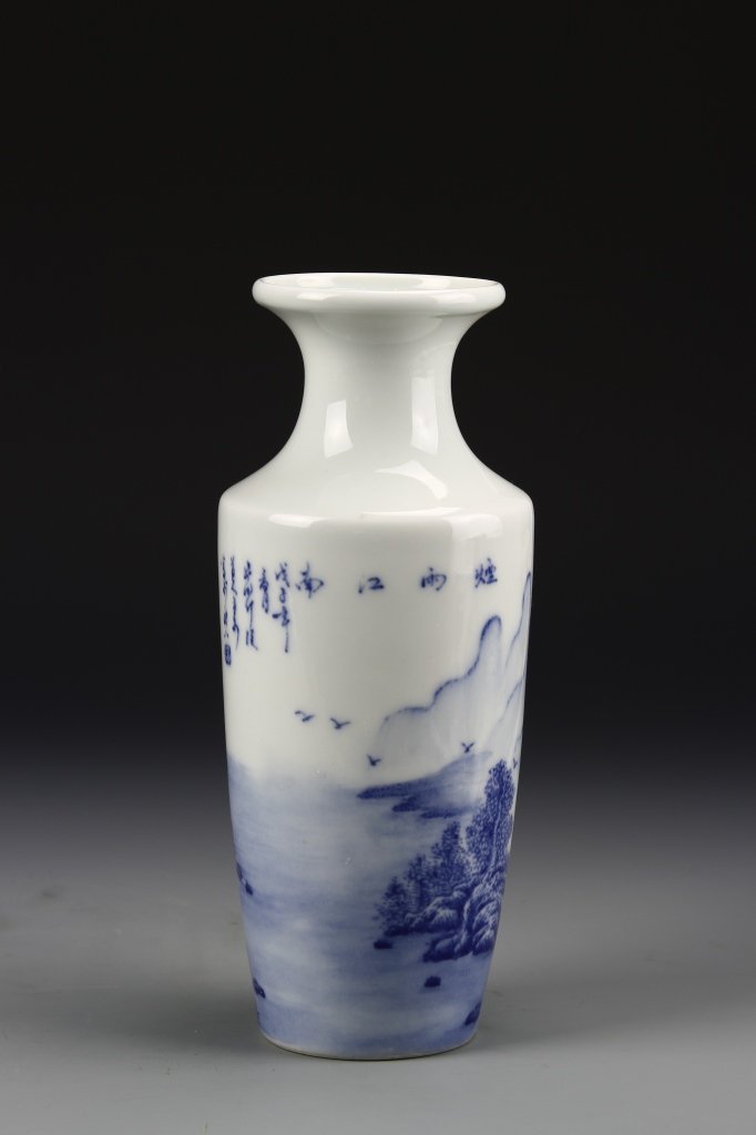 Chinese Blue and White Vase: China, ROC, blue and white vase signed Wang Bu, scene depicting birds flying by a stream against trees and mountains in pale blue paint against white ground with mark on base. Height 9 7/8 in.