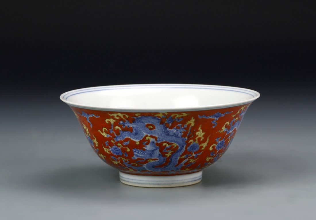 Chinese Famille Rose Bowl: China, 19th C., Famille Rose bowl, Ming mark on base. Blue dragon with yellow flourishes on a red ground. Resting on a white circular foot. Width 6 in., Height 2 1/2 in.