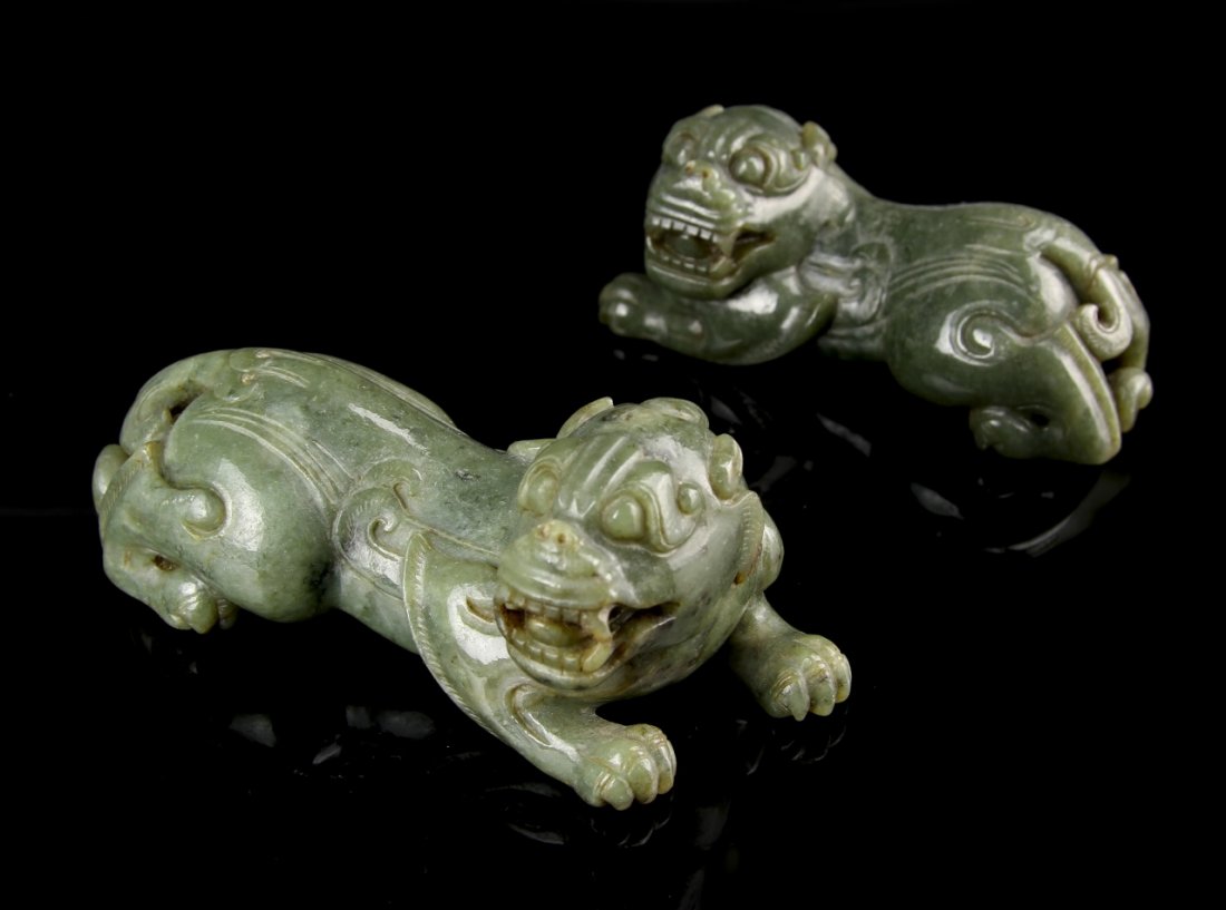 Two Chinese Jade Foo Lions: China, Roc Period, Two Jade Foo Lions, Both In Reclining Positions, With Carved Details And Teeth Showing, In Green Hues. Length 4 In.