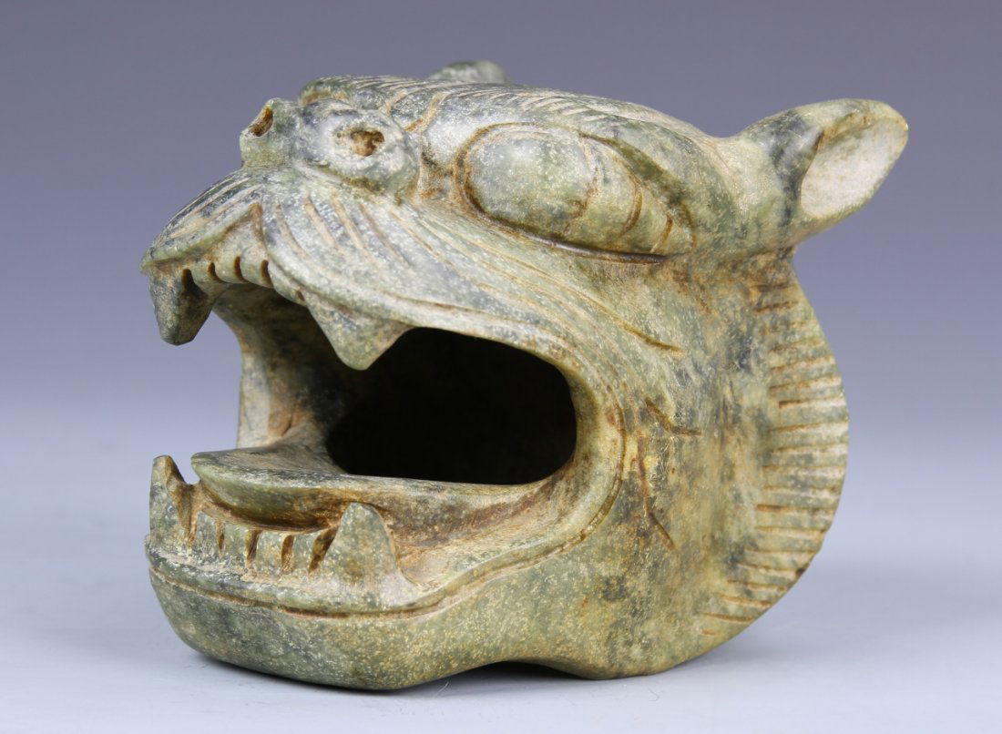 Chinese Jade Tiger Head: China, antique jade tiger head, with a gaping open mouth showing carved teeth, with hair detail and an animated facial expression. Height 4 1/2in., Width 5 1/2 in.