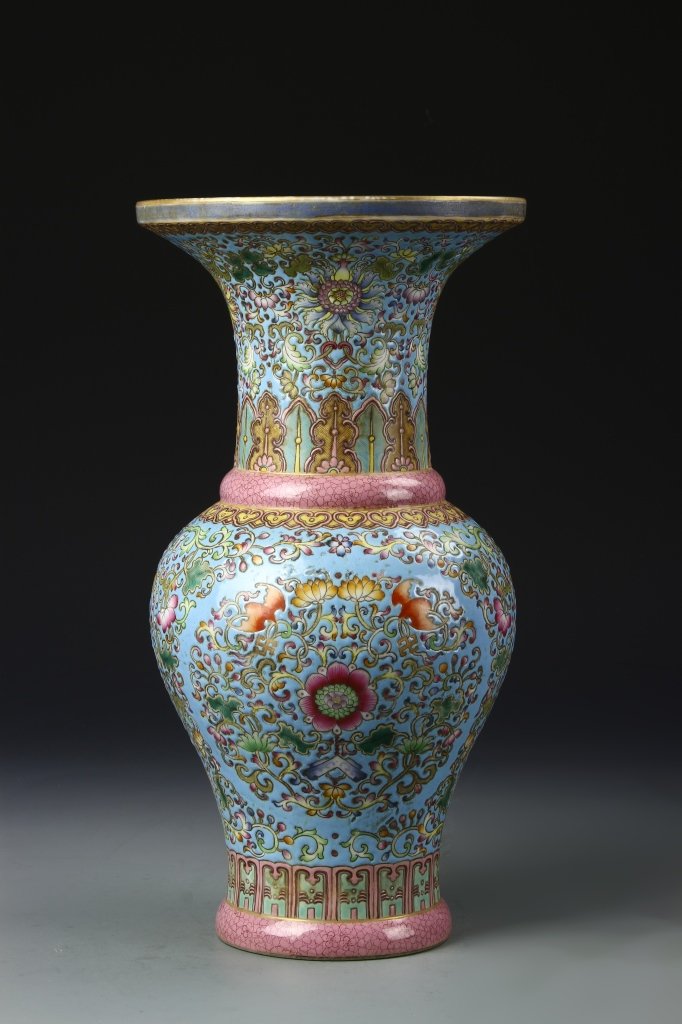 Chinese Famille Rose Gu Vase: China, ROC, Famille Rose Gu vase, flared mouth, wide shoulders, undulating sides to flat base, dense floral decoration throughout with gilt rim and pale blue ground. Height 14 1/2 in.