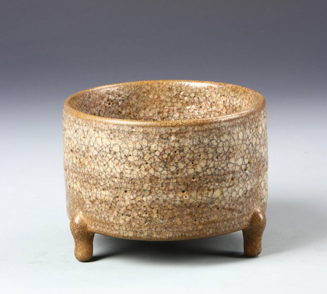 Chinese Tripod Brown Glazed Censer: China, antique tripod brown glazed censer, short, cylindrical body on three stout legs, beige and splattered brown coloring throughout, dull finish. Width 4 1/4 in., Height 5 3/4 in.
