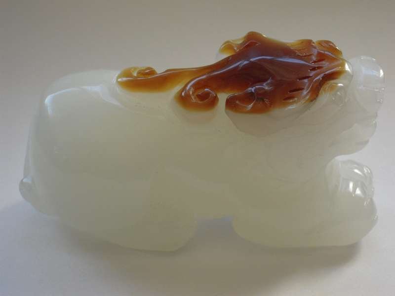 Chinese Jade Foo dog: Chinese Hetian Jade Carving ornaments.retain some of the stone skin. Size 3 1/4" x 1 1/2"