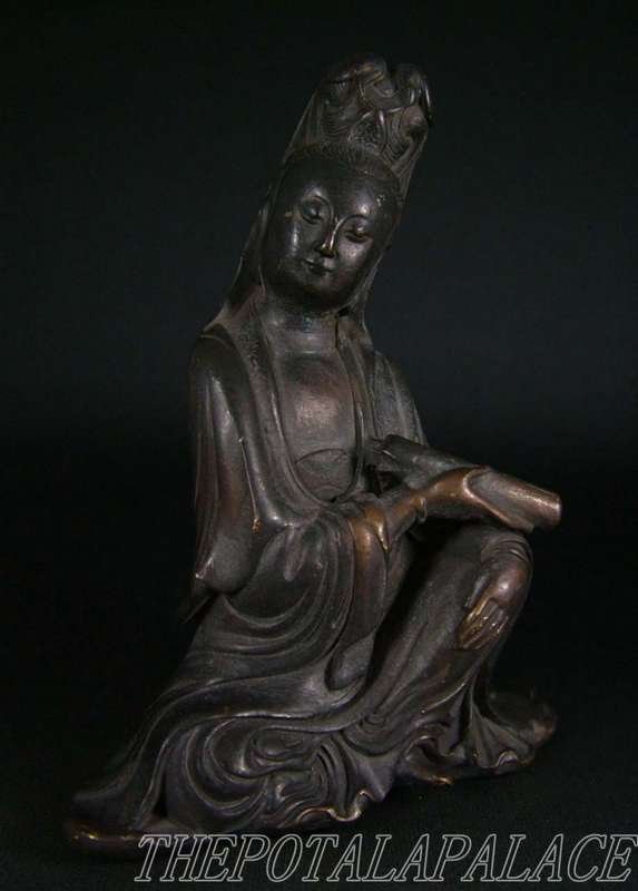 Chinese bronze Guanyin: Finely cast to depict a seated Guanyin, one arm resting on a stack of Buddhist texts. Size 4 1/4" High