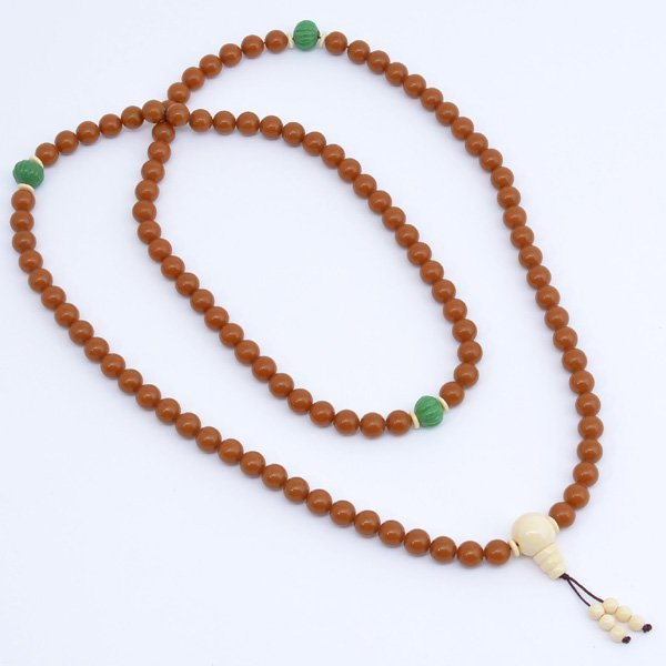 Chinese Amber(Mi-La) Buddhist Beads: Chinese Amber(Mi-La) Buddhist Beads, consisting of 108 spherical amber beads each 1.3 cm diameter with opaque mustard color, 48" overall.