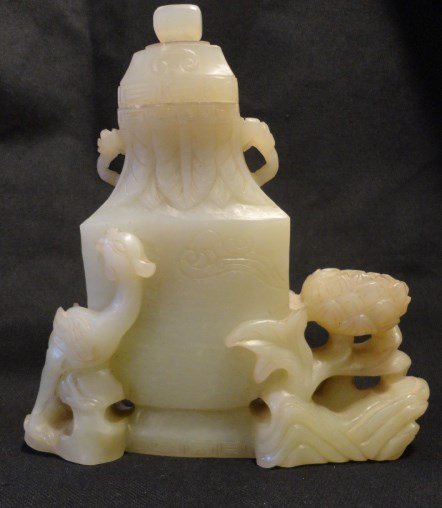 Carved Jade vase W/ Phoenix and Lotus: Elegant carved with jade vase with lid. Wonderful three dimensional carving at base of vase of a phoenix and lotus flower pod. 6"L x 2"W x 6.5" H.