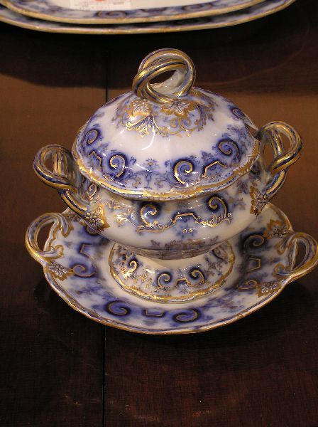 Flow Blue Sauce Tureen Doric Pattern: Flow Blue Doric pattern sauce tureen with underplate and gilt trim. Signed W&B Doric. Circa 1860. Measures 8 inches tall