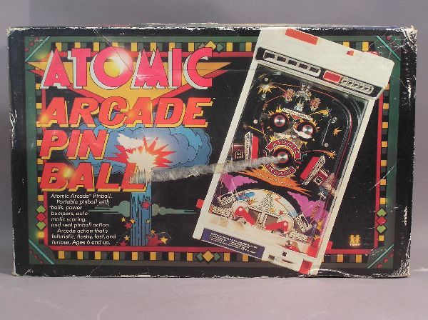 Atomic Arcade Pin Ball Game: Atomic Arcade Pin Ball Game. Made by Tomy 1979. Portable pin ball machine with bells, bumpers, automatic scoring. Has been played and in working condition. Uses five D-cell batteries. Measures 16 inch