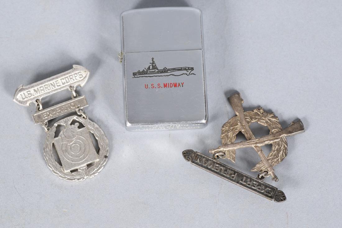 Vintage Sterling USMC Marksman Pins, Zippo USS Midway: Nice small lot of marksman pins for a USMC Lt. Col, one sterling Expert Rifleman, and one not sterling Ex-Pistol. Included is a nice Zippo lighter with a USS Midway tribute etched in.From the estate o