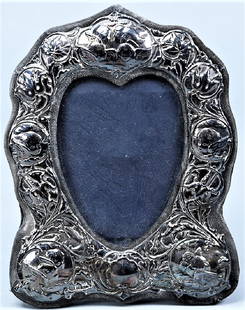 1985 Sterling Keyford Frames Ltd. Frame: Pretty sterling frame from Keyford Frames Ltd. This wood frame is wrapped in deep navy with a repousse sterling overlay. The frame is well marked with a lion passant, leopard head assay mark and a cur