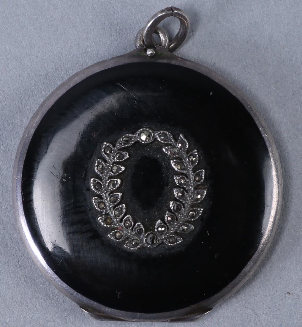 Antique German Sterling Black Enamel Locket: Lovely round locket with black enamel. Appears to be a mourning piece. The locket front is adorned with a laurel wreath encrusted in marcasites. Inside the locket is stamped on each side 9 I and a sta