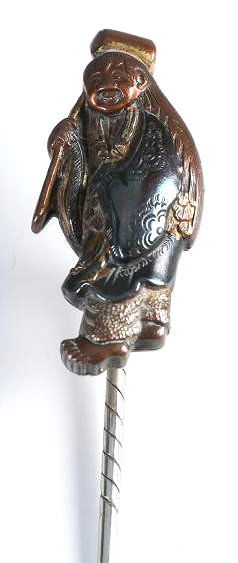 17th C Konkan Iwamoto Menuki Stick Pin: Lovely bronze Menuki in the form of Daikoku. His upper shoulder has been signed by Konkan Iwamoto (1744-1801).This Menuki has been converted into a stick pin. Daikoku measures just over 1" long, the o