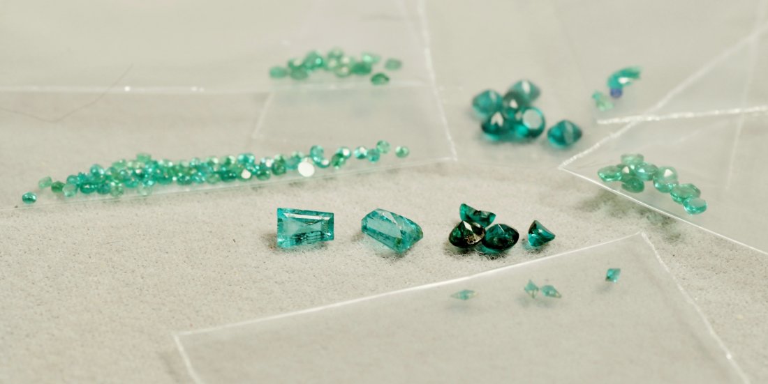 Lot of Various Faceted Emeralds: Excellent lot of vintage emeralds. Gem packets give measurements varying in sizes from 2mm to 2 1/2mm with larger ones. There are 2 trapezoid emeralds, approx 1/3ct ea. Most are rounds with a few odd 