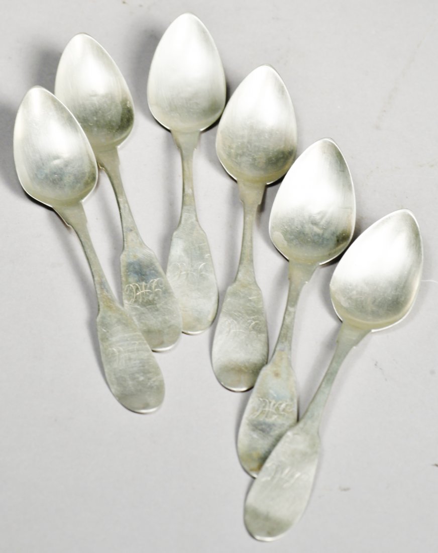 c1850 Canfield Bros & Co Coin Silver Spoons: Lot of 6 c1850 coin silver spoons. Each spoon is marked with a star and an eagle in a cartouche with C.B. & Co, attributed to Canfield Bros. & Co. Each fiddle back spoon is monogrammed LMC and measure