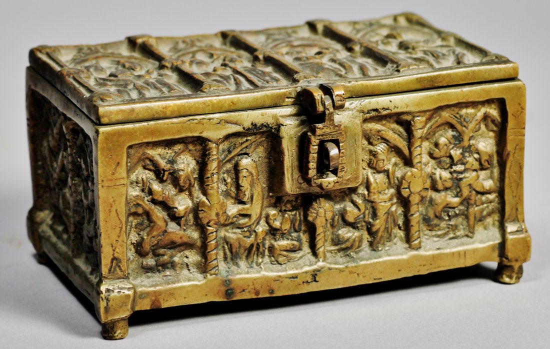 Antique Victorian Heavy Brass Casket with Figures: Very heavy, and rather primitive brass casket. Appears to have a religious theme. Figures standing under flying buttresses. Appears to be brass but may be cast iron with a gold tone paint. The lid doe