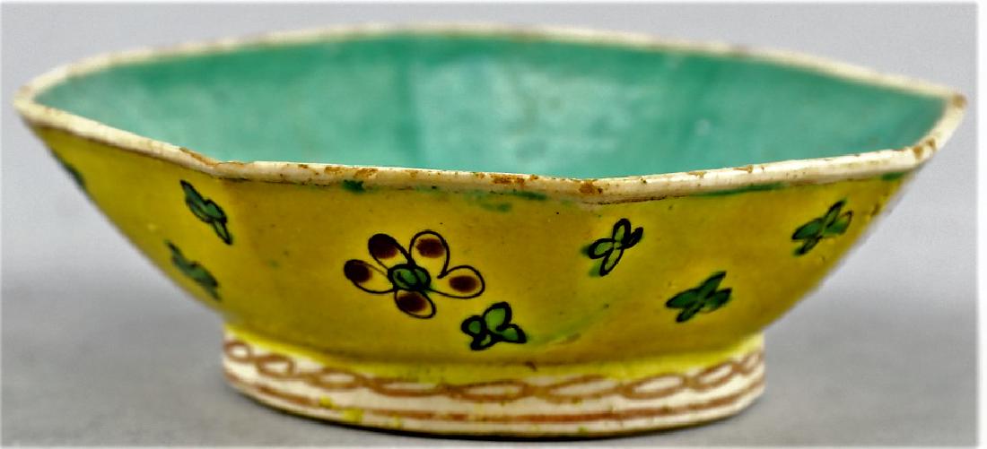 Chinese Octagonal Yellow Ground Bowl: Nice antique octagonal yellow ground footed bowl with flower motif. 2" high x 6" dia. Green interior of bowl and on underside, no marks.This item is from the estate of a gentleman from Gaton Lamps on 