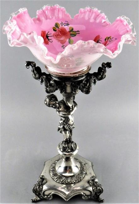 Aesthetic Silver Plate Cherub Fruit Bowl: This gorgeous fruit bowl on stand is unmarked. It is topped with a pink cased ruffled glass bowl with polychrome flowers. Dragon details at the base of the bowl with loops for adding hanging crystals.