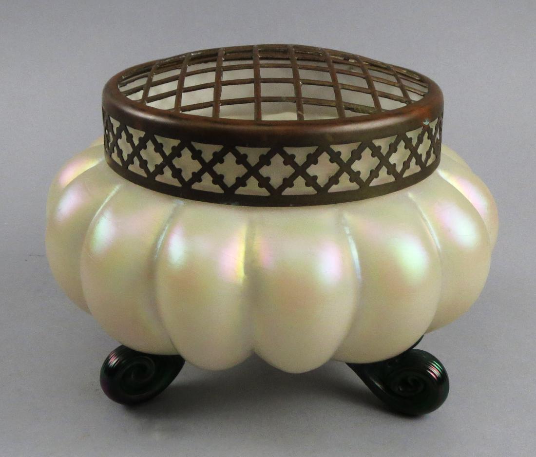 Antique Loetz Iridescent Glass Flower Frog: Beautiful c1900 Loetz glass flower frog in a mellon shape. This piece comes with a reticulated brass lid and applied green scroll feet. Stands approx 5 1/2" tall, 8" diameter