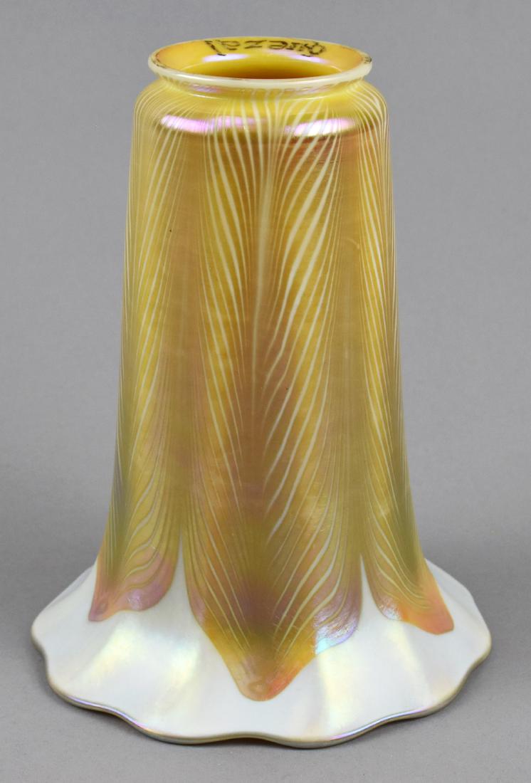 Signed Quezal Tall Pulled Feather Art Glass Shade: Beautiful signed Quezal art glass shade. Golden interior glass with a golden pulled feather design beginning at the fitter and extending to flare of shade on a white iridescent edge. Height 6.5", fitt