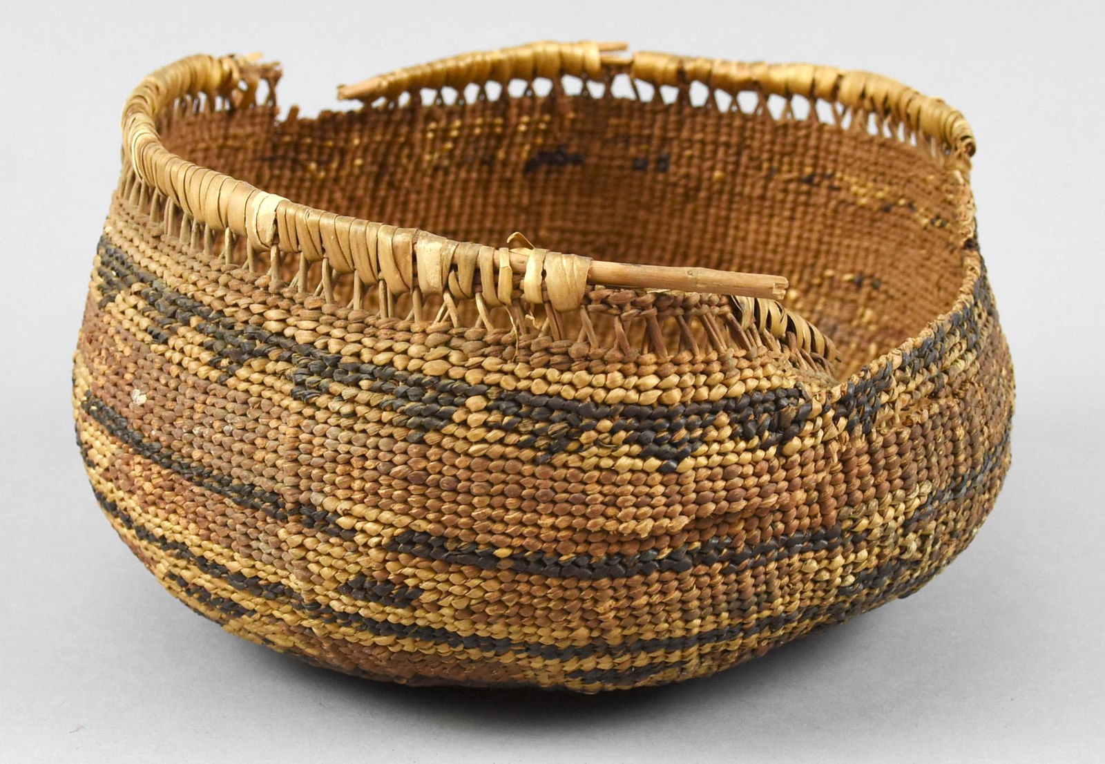 Antique Native American Indian Basket: Antique Native American basket. In fair condition much wear and loss, but still an interesting decorative piece. Dimensions are 7" across and 4" high.