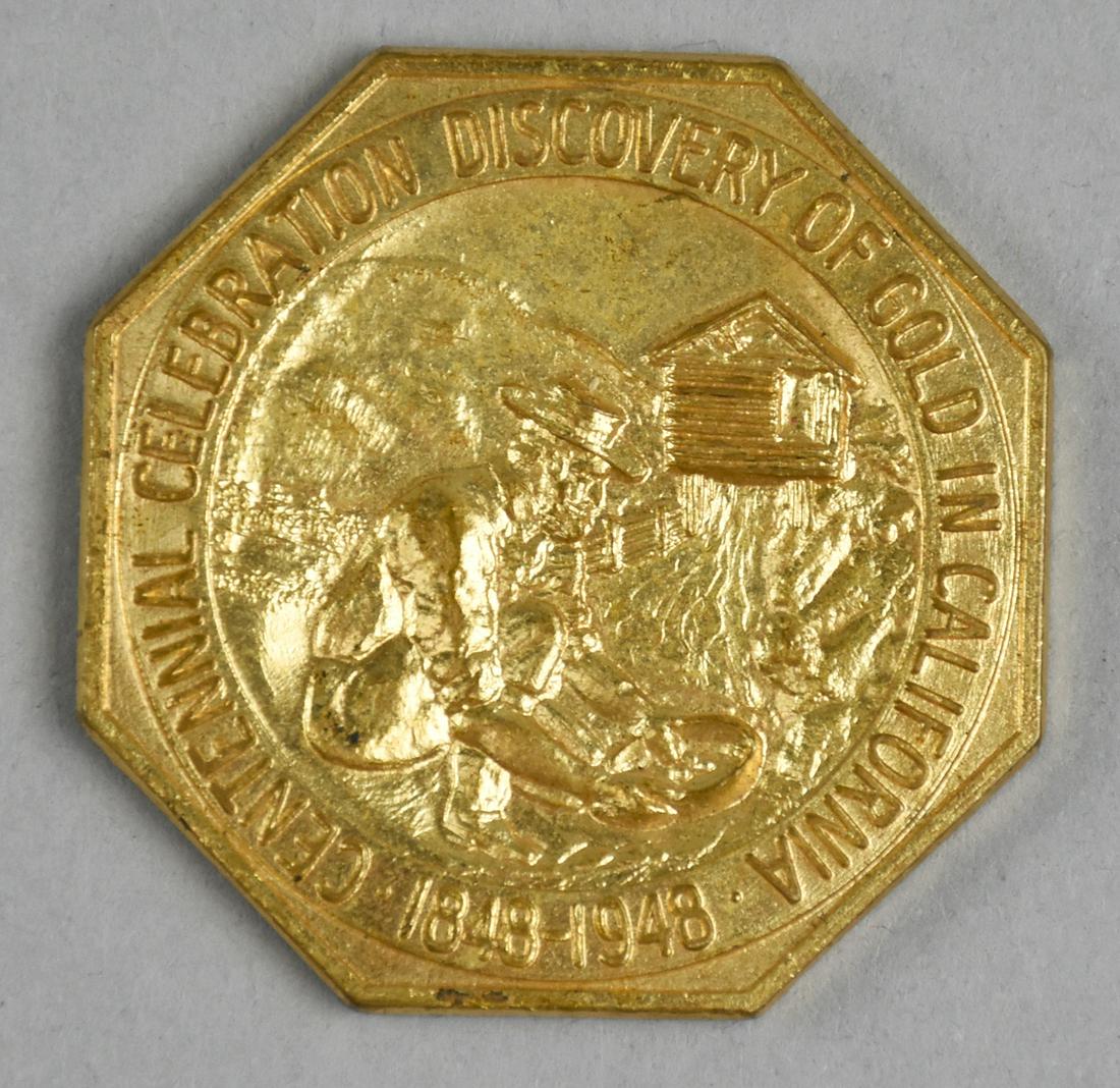 1848-1948 Centennial Celebration Discovery of Gold Cali: Octagonal shaped token celebrates the discovery of gold in California. Featuring a gold panner in the river with his cabin in the background on the front of the token and on the obverse, is an indian