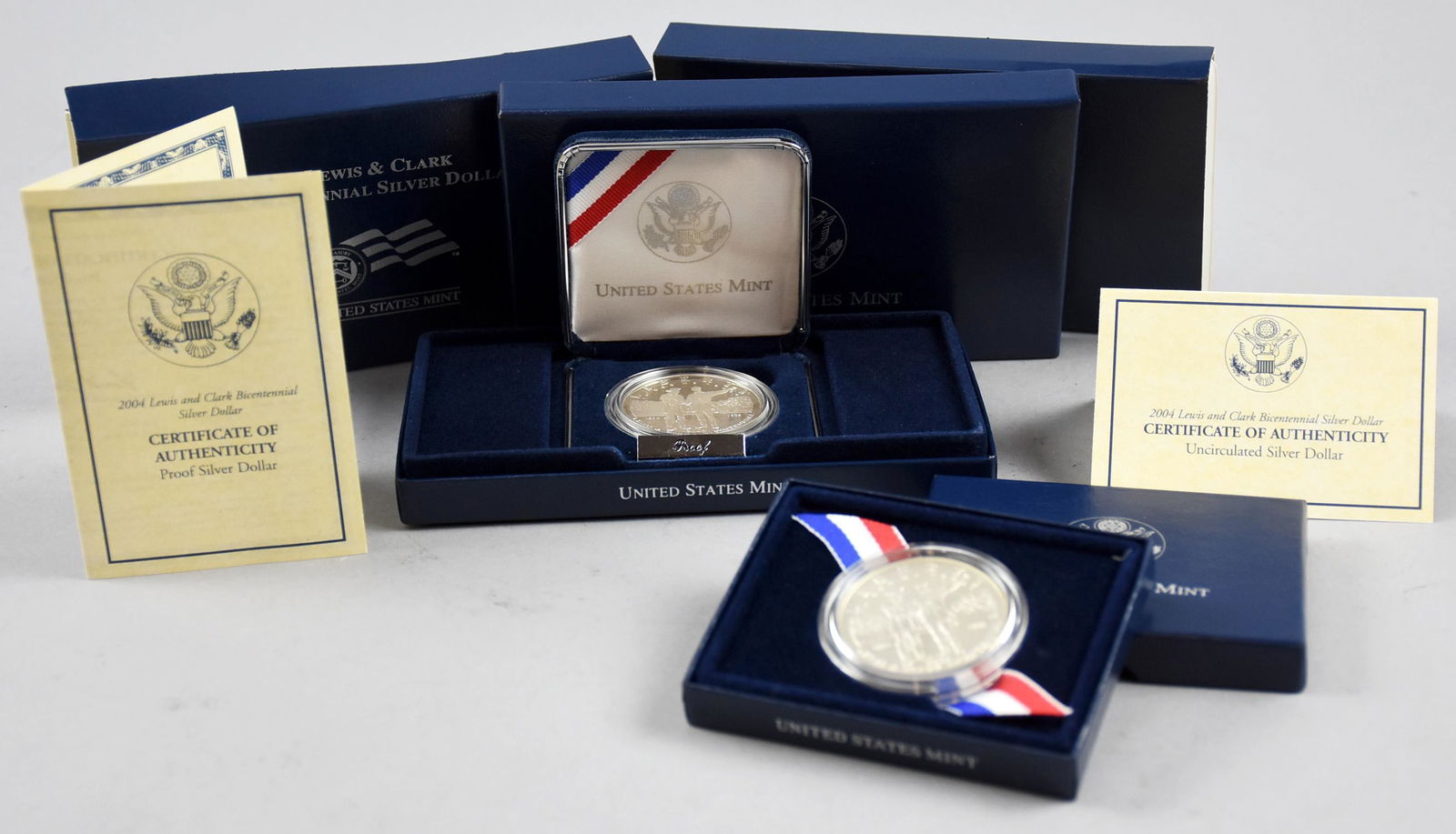 Lot of 2 Lewis & Clark Bicentennial Silver Dollars: This is a very nice lot of 2 Lewis & Clark Bicentennial 90% Silver Dollars, 3/4ox ea. One is a Proof Silver Dollar and the other is Uncirculated. Both depict Meriwether Lewis and William Clark on a st