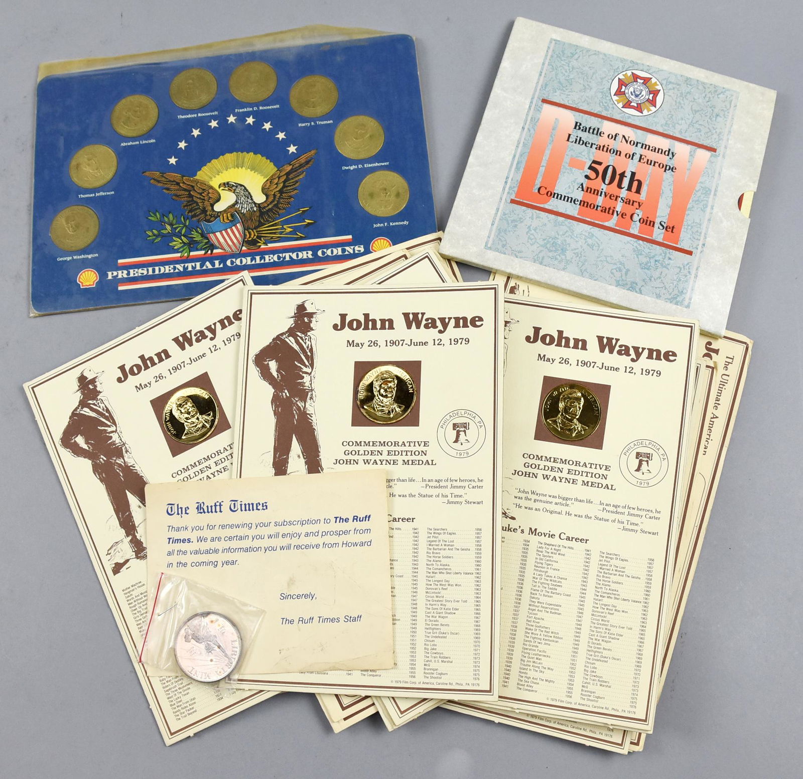 Lot of 8 John Wayne Coins, a Silver Round, Shell: This lot contains 8 Commemorative Golden Edition John Wayne Medals, along with John Wayne timeline and a certificate of Authenticity from the American Treasury Mint. A one troy ounce, .999 Fine Silver