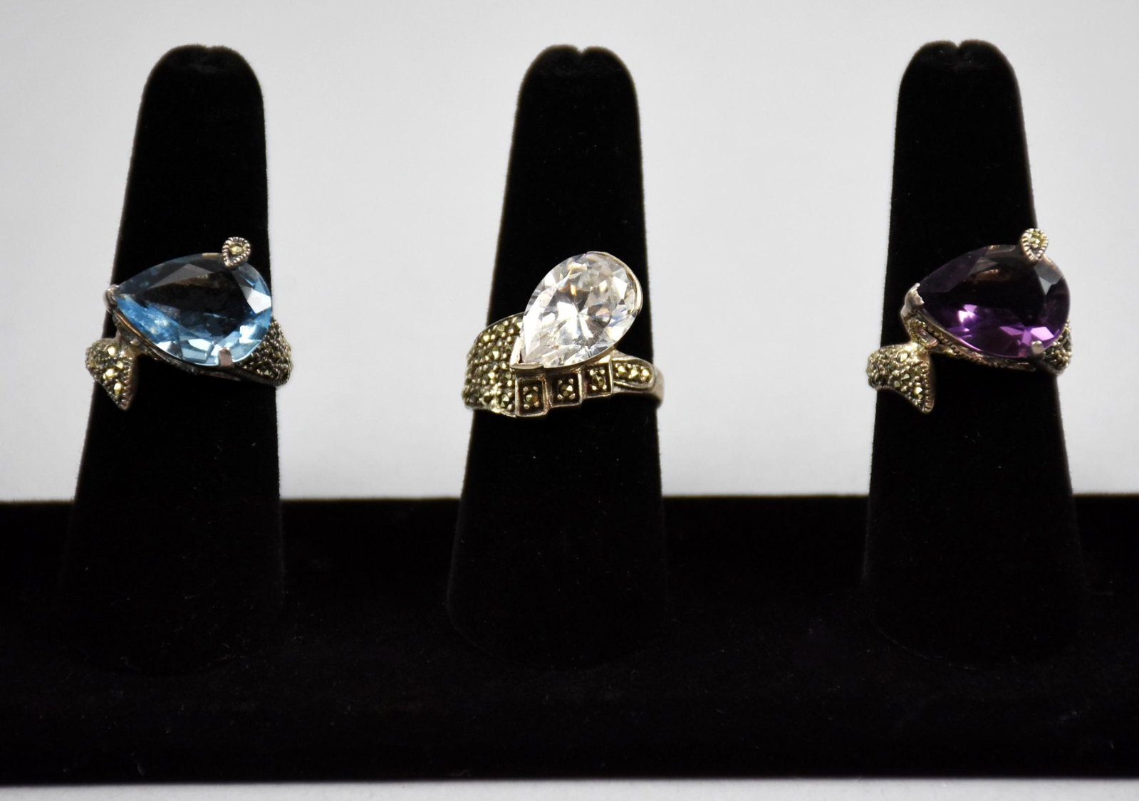 Lot of 3, Teardrop Crystal Rings, Hava: These are very cool rings from Hava. Each is sterling, each has a teardrop cut crystal, blue, amethyst and clear, each adorned with marcasite. Each stamped 925, blue and amethyst approx size 7, clear 