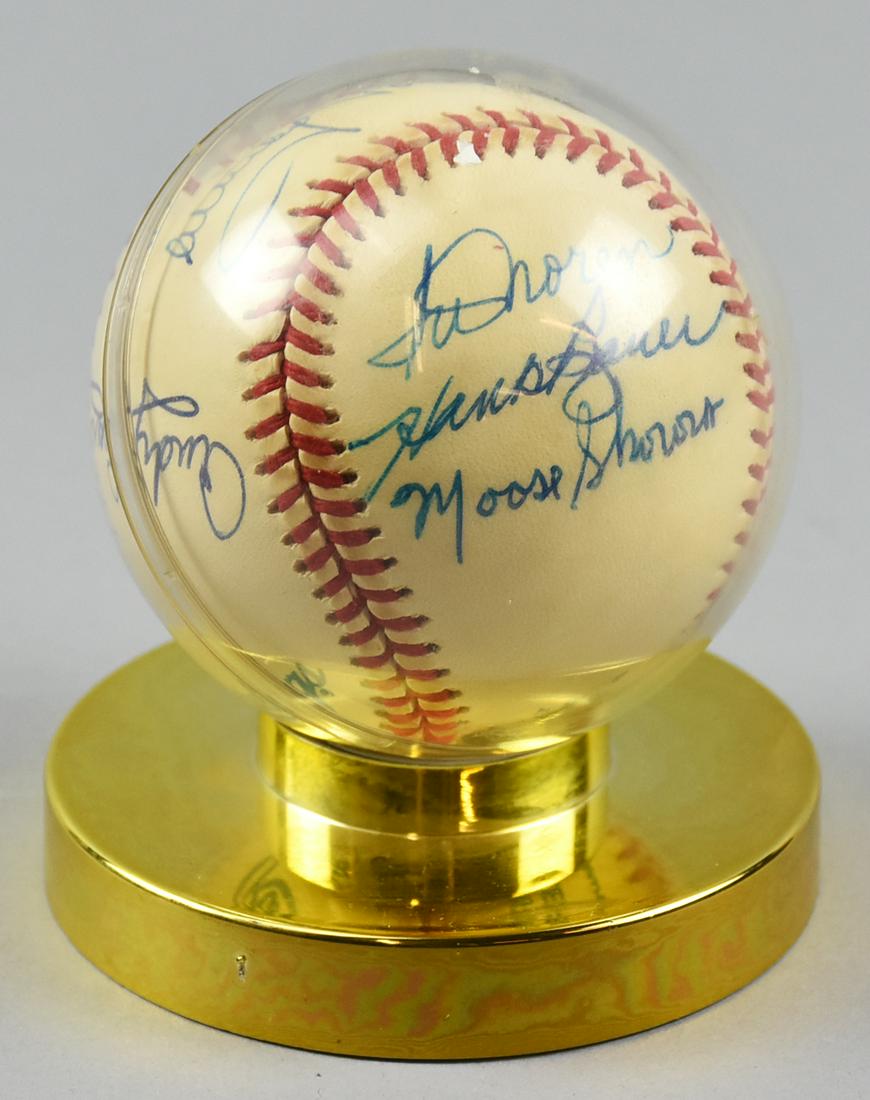 New York Yankees Pitchers Multi Signed Ball: Several of the New York Yankees pitchers signed this ball, some of the greats that include Whitey Ford, Moose Skowron, Hank Bauer, to name a few. Ball is in a plastic display, light discoloration of t