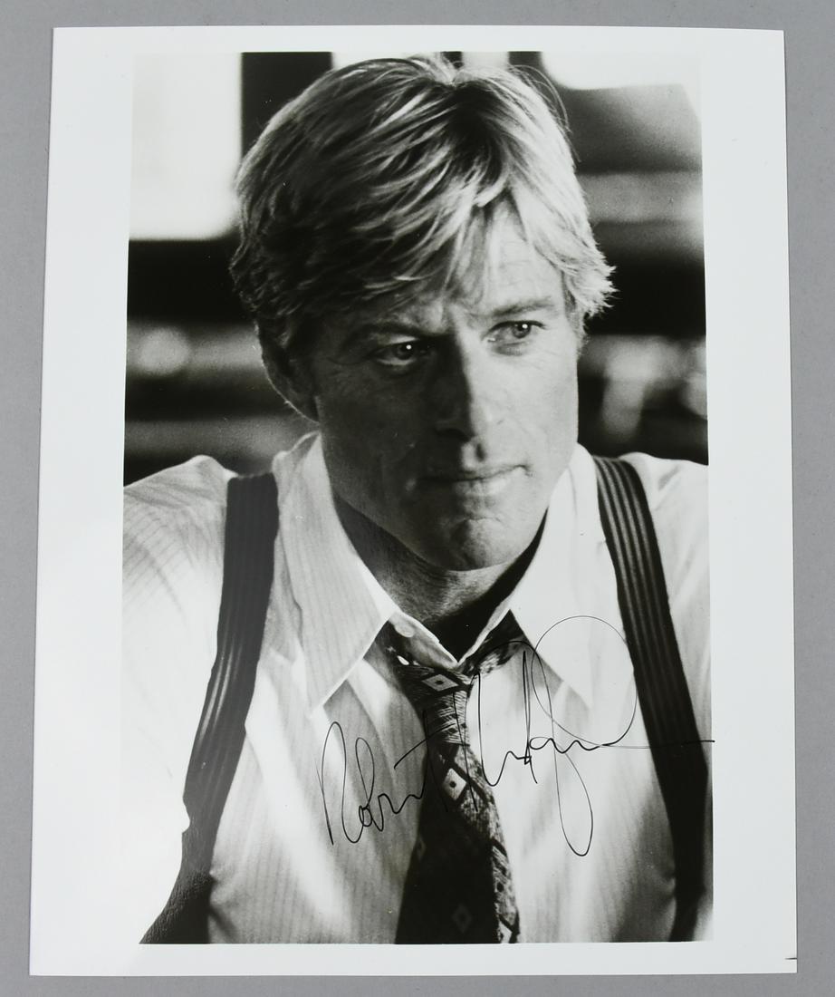 B&W Glossy Robert Redford Photo: Appears to be a movie still of Robert Redford. The 8x10 glossy has been signed in black ink across his tie.