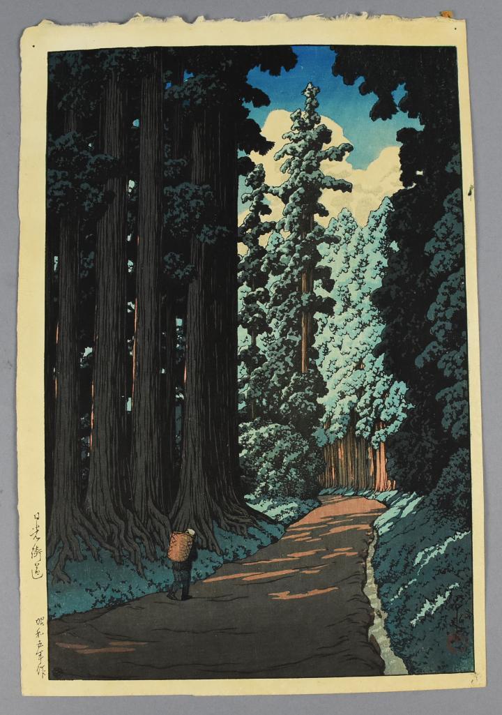 Kawase Hasui (1883-1957) Woodblock Print: Road to Nikko is a lovely woodblock print from Japanese artist Kawase Hasui from 1930. Signature and publisher mark visible under rich blues. Approx measures 15 3/8" x 10 3/8"