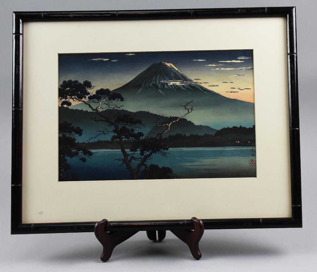 Tsuchiya Koitsu (1870-1949) Japanese Woodblock Print: Evening View from Lake Sai is a 1938 woodblock print from artist Tsuchiya Koitsu. Clearly marked with artist stamp and publisher Doi Sadaichi. Nicely framed in a black painted bamboo with matte. 