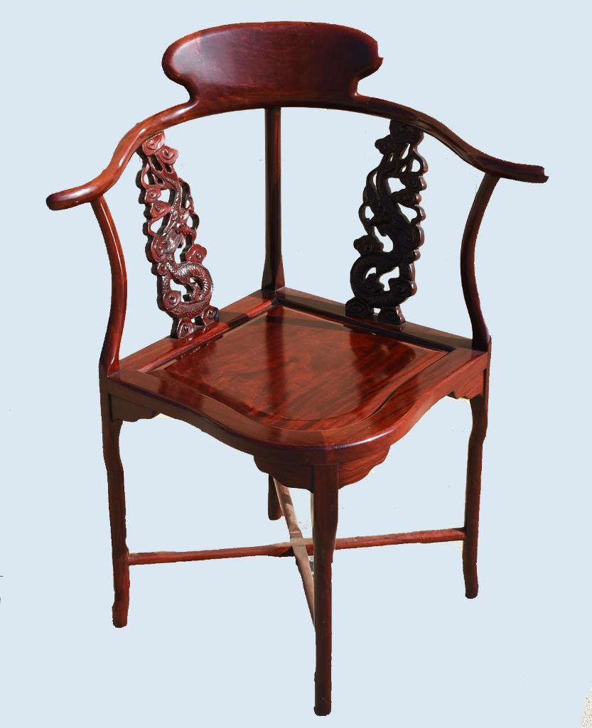Antique Chinese Import Carved Rosewood Corner Chair: This beautiful corner chair appears to be carved rosewood. The carved side rails are dragons with spirals. The rest of the chair is smooth and all very nicely polished, constructed with flat head 