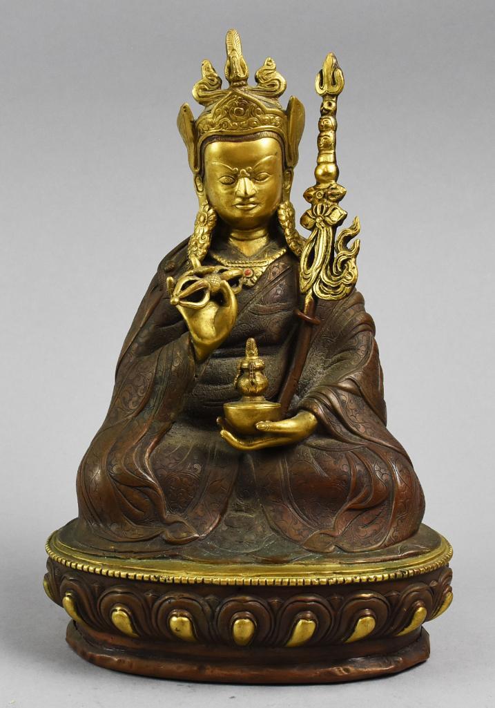 Tibetan Gilt Bronze Guru Padmasambhava: Beautiful gilt bronze of Tibetan Guru Padmasambhava. Sitting with a vase in hand and a loop for a scepter in his robes. Ornate stamped mark in the base, measures approx 9 1/4" x 5 1/2" x 4".