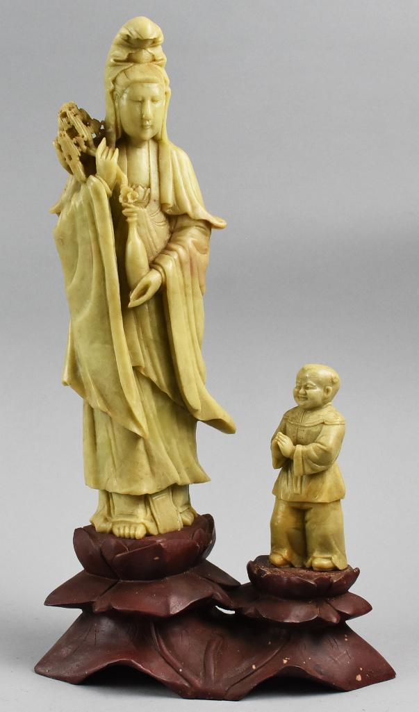 Soapstone, Guanyin Compassion God & Base Chinese: Wonderful carved soapstone Guanyin, Goddess of Compassion. She stands with a small figure on a carved soapstone base. Overall approx height 15 3/4" x 8 3/4".