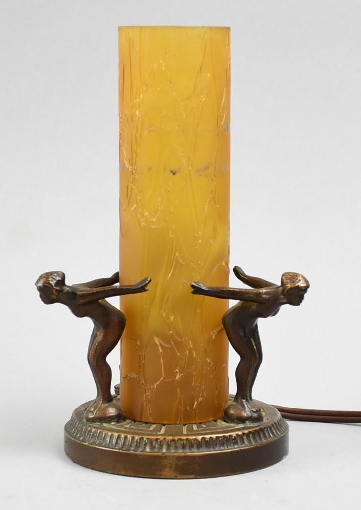 Frankart Style Art Deco Figural Nude Lamp: This great lamp is in Frankart style featuring three nude figural women in what appears to be a diving stance. The women surround an amber color, textured glass cylinder globe. The cord appears to