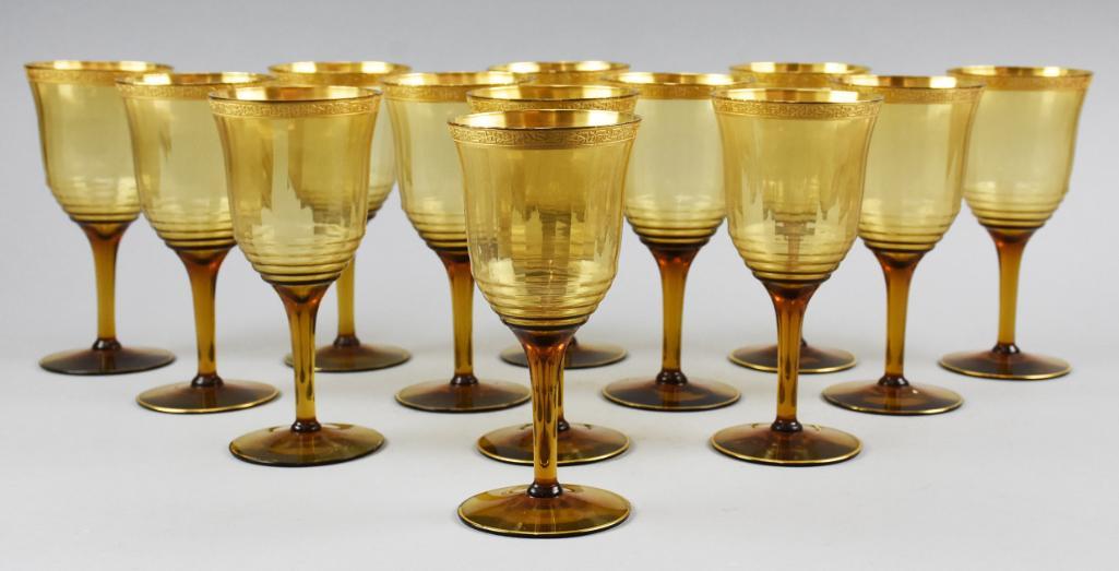 13 Elegant Gold Rimmed Wine Glasses Tiffin ?: Set of 13 vintage tulip-form gold rimmed amber color wine glasses. These match the other lot of gold rimmed glasses. They stand 6.75" tall x 3.25" wide at top. These may be Tiffin.