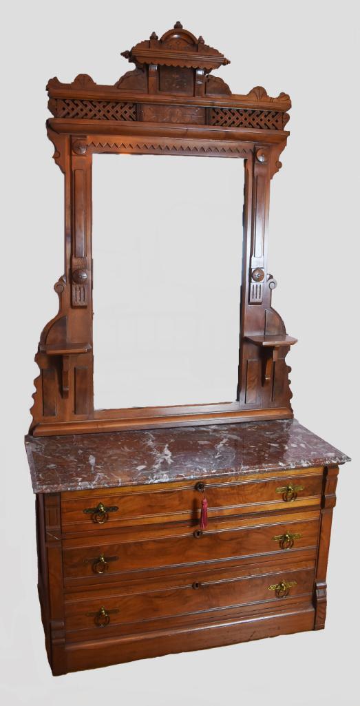 C1860 Eastlake Carved Marble Top Dresser: Wonderful antique dresser is attributed to Eastlake. Intricate carving and lattice detail adorns the top of the mirror and the frame also has carved medallions candle shelves and sawtooth carving. The