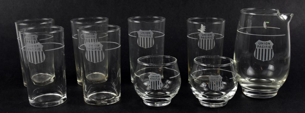 Lot of 9 Union Pacific Railroad Glassware by Libbey: Fun and usable is this nice small set of Union Pacific drinkware glasses. Consists of six tumblers approx 4 1/4" tall, two small glasses, approx 2 5/8" tall with a carafe, approx 5 1/4" tall. All acid