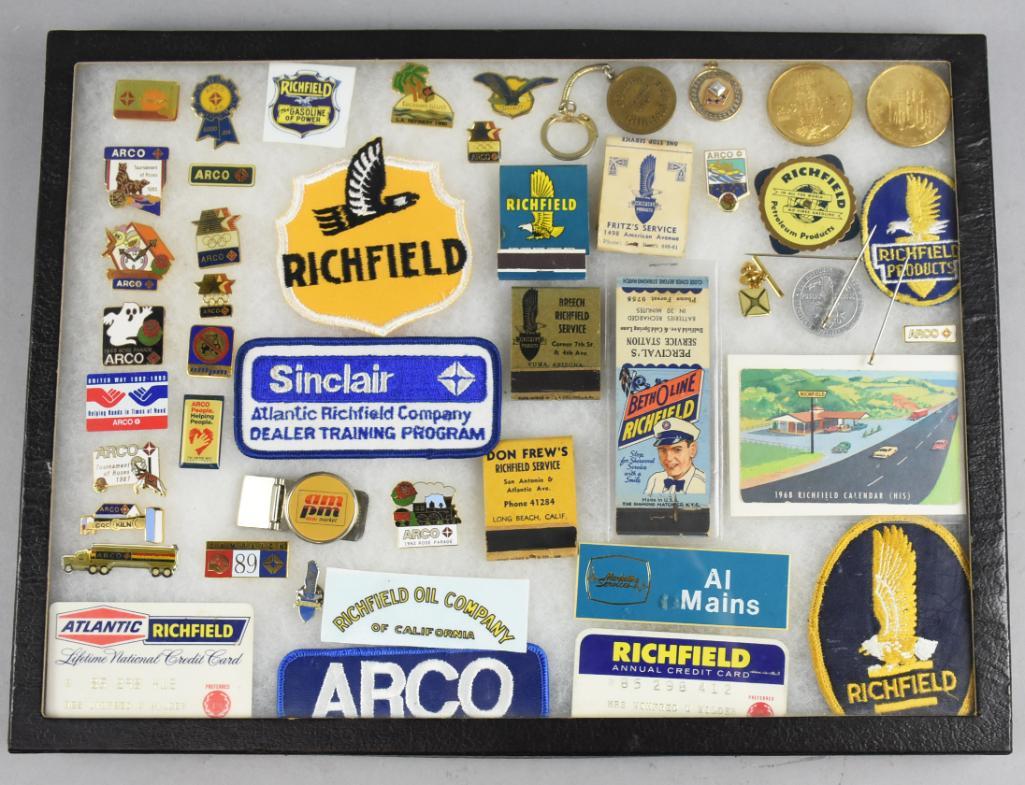 Richfield & Arco Patches, Pins, Matchbooks and More: This is a full riker display case filled with Richfield and Arco goodies. Includes pins, patches, keychains, matchbooks and more. Case measures 16.5" x 12.5" x 1" tall.