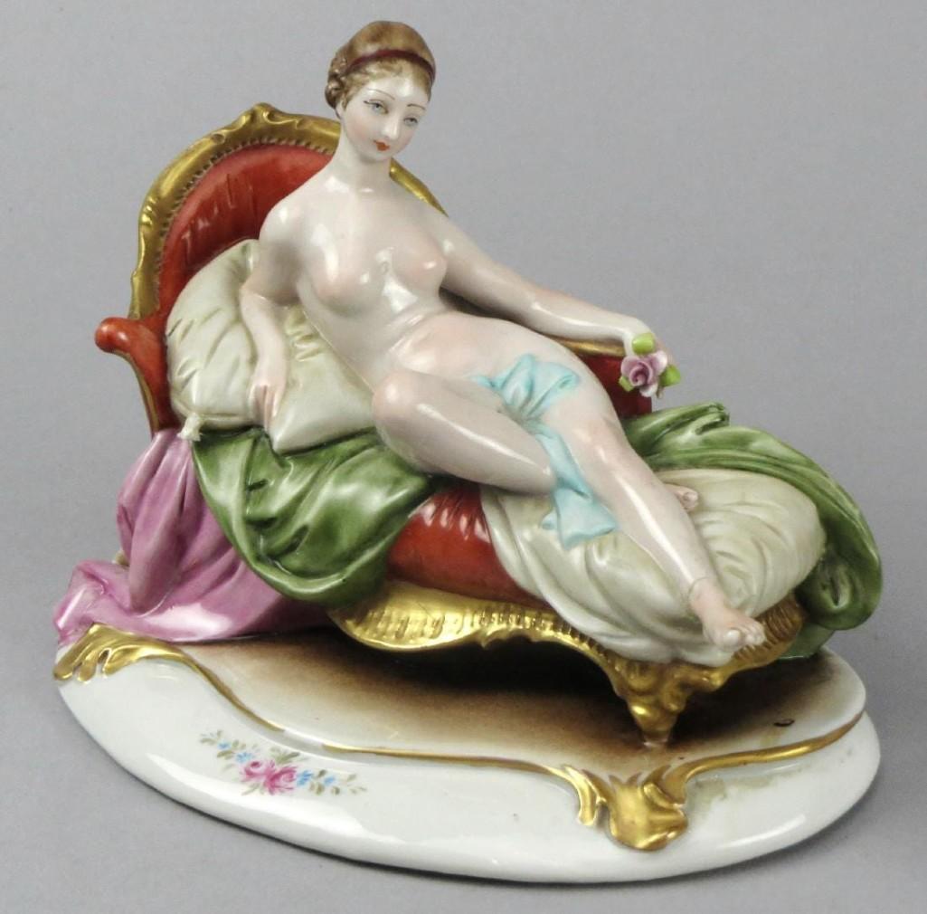 Vintage Capodimonte Cappe, Reclining Nude: Beautiful porcelain figurine of a nude woman lounging on a settee. She is mostly uncovered and propped up on pillows. The back is marked with the 1925-1967 Capodimonte mark along with Cappe (Guiseppe