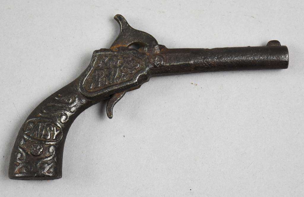 c1875 J&E Stevens Cast Iron Daisy Cap Gun: Nearly 150 years old and this little cast iron gun looks great. It is a J&E Stevens cap gun called Daisy, with a daisy and pretty scroll details. It is showing a patent date on the other side that has