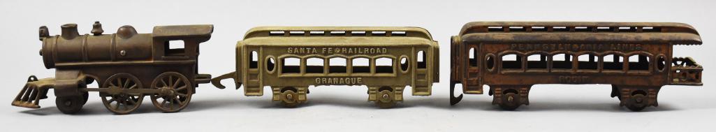 c1930 Kenton Locomotive & Passenger Cars, Santa Fe Plus: Nice lot of Kenton Hardware Co cast iron floor pull toys. Lot is one locomotive that is unmarked, a Santa Fe Granague passenger car and a Pennsylvania Lines Rouin observation car.