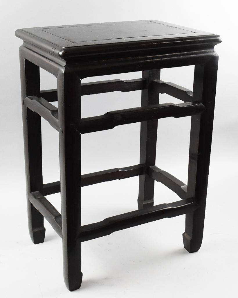 Chinese Black Wood Side Table: Beautiful hardwood table of Chinese origin. It is black with simple carved lines around table top and curved stretchers. Measures 12" x 17" and 24" tall.