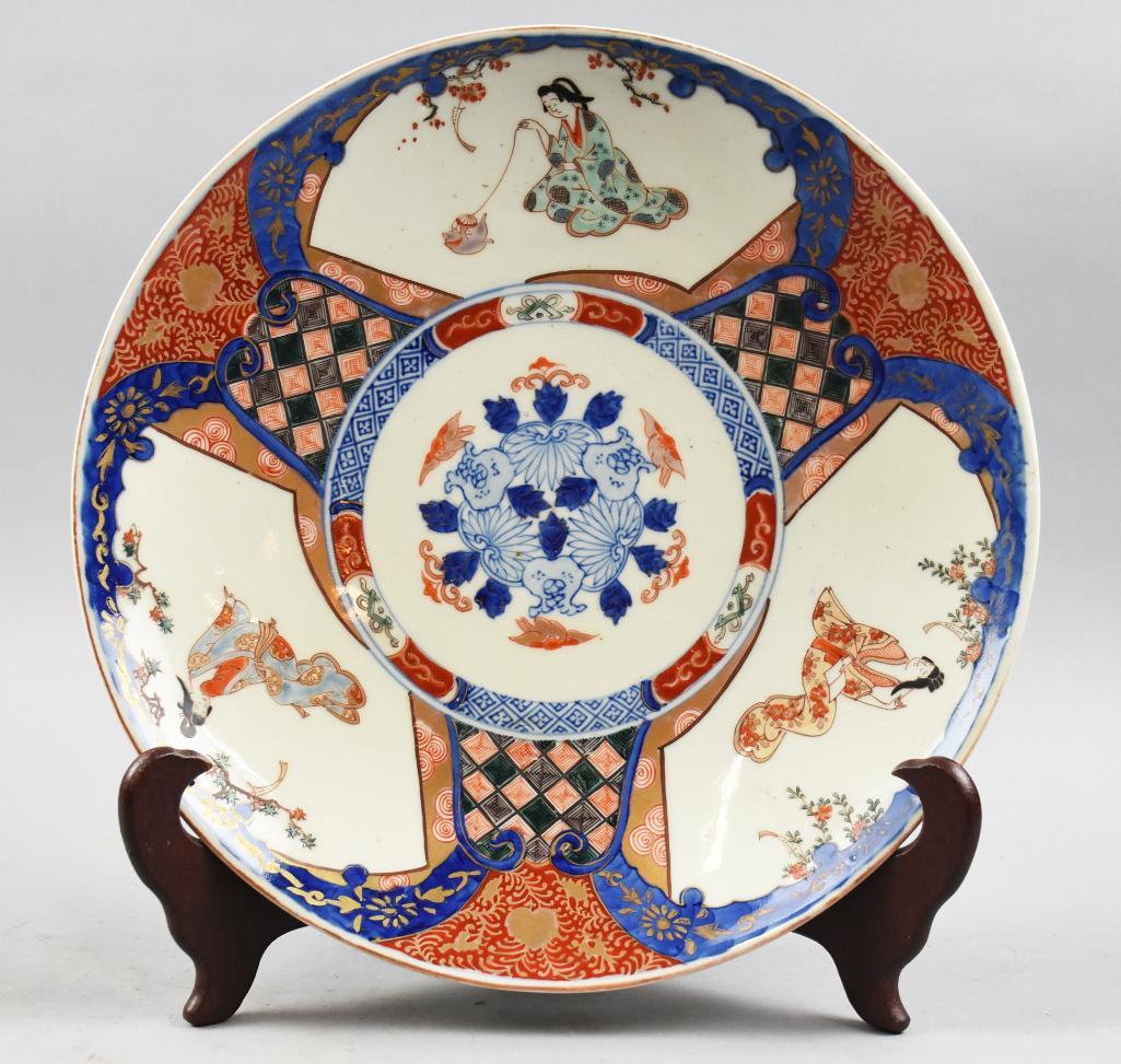 Antique Japanese Imari Porcelain Shallow Bowl: Gorgeous porcelain bowl of Japanese origin. Bowl is expertly hand decorated with iron red and cobalt glaze. Outer rim is also decorated with a floral motif. It is unsigned and measures 13" across x 2"