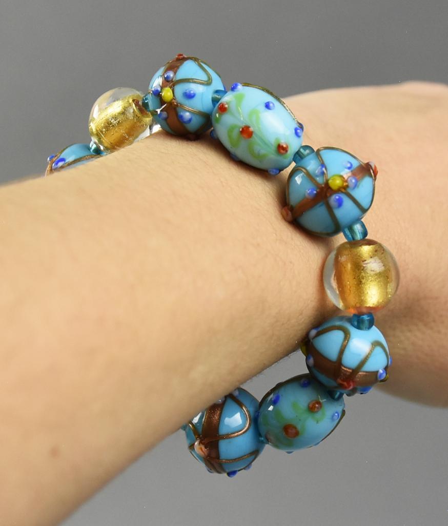 Venetian Art Glass Bead Bracelet: This wonderful art glass bead bracelet is Venetian. Each bead is hand crafted in very ornate detail with three beads having mica gold flakes. It has stretch!