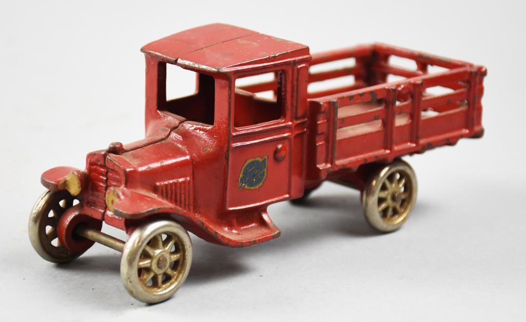 c1925 Arcade Cast Iron Stake Truck No. 203, Orig Label: Wonderful c1925 Stake Truck from Arcade. This cast iron red truck is embossed inside the number 203. Wheels of steel are original and truck retains 90-95% original paint and the original paper Arcade 